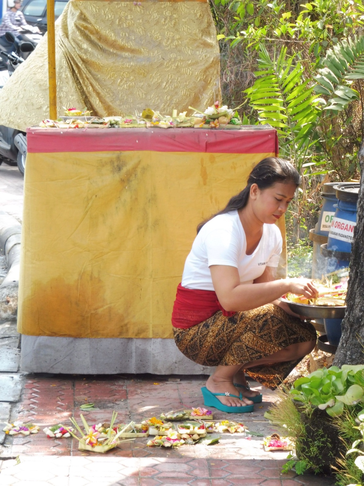 Woman laying the offerings 